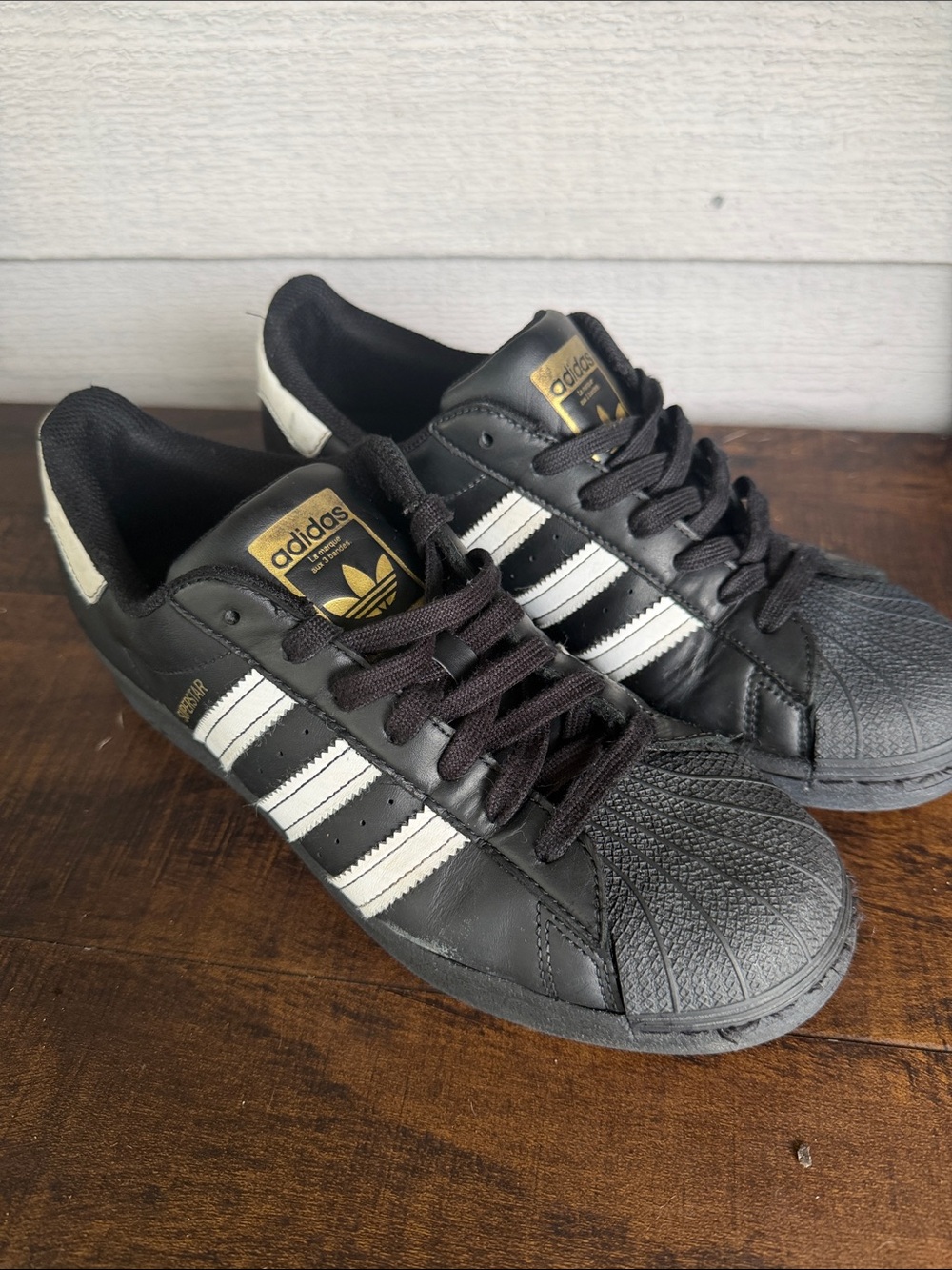 adidas Black and White Classic Superstar Sneakers with Gold Tongue Logo